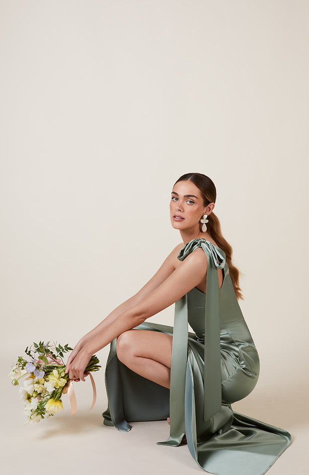 Satin one shoulder bridesmaids dress in sage green with a detachable bow. A beautiful rich mint marine green this dress is a modern and stylish option for all occasions.