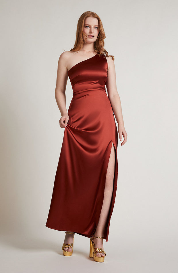 Satin one shoulder bridesmaids dress in burnt orange with a detachable bow. A beautiful rich copper rust colour, this dress is a modern and stylish option for all occasions.