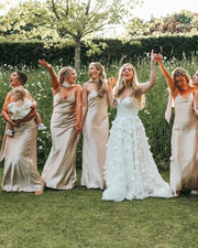 Bridesmaids in champagne satin dresses