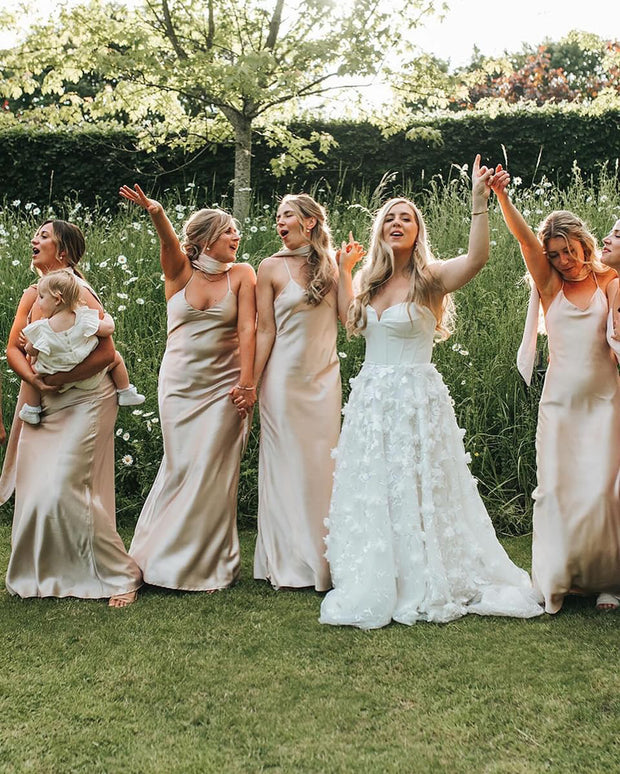 Bridesmaids in champagne satin dresses