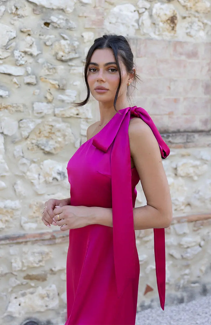 Satin one shoulder bridesmaids dress in hot pink with a detachable bow. A beautiful rich fuchsia magenta pink this dress is a modern and stylish option for all occasions.