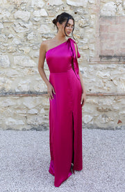 Satin one shoulder bridesmaids dress in hot pink with a detachable bow. A beautiful rich fuchsia magenta pink this dress is a modern and stylish option for all occasions.