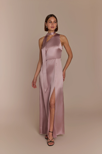 Woman wearing a rose pink satin one shoulder gown