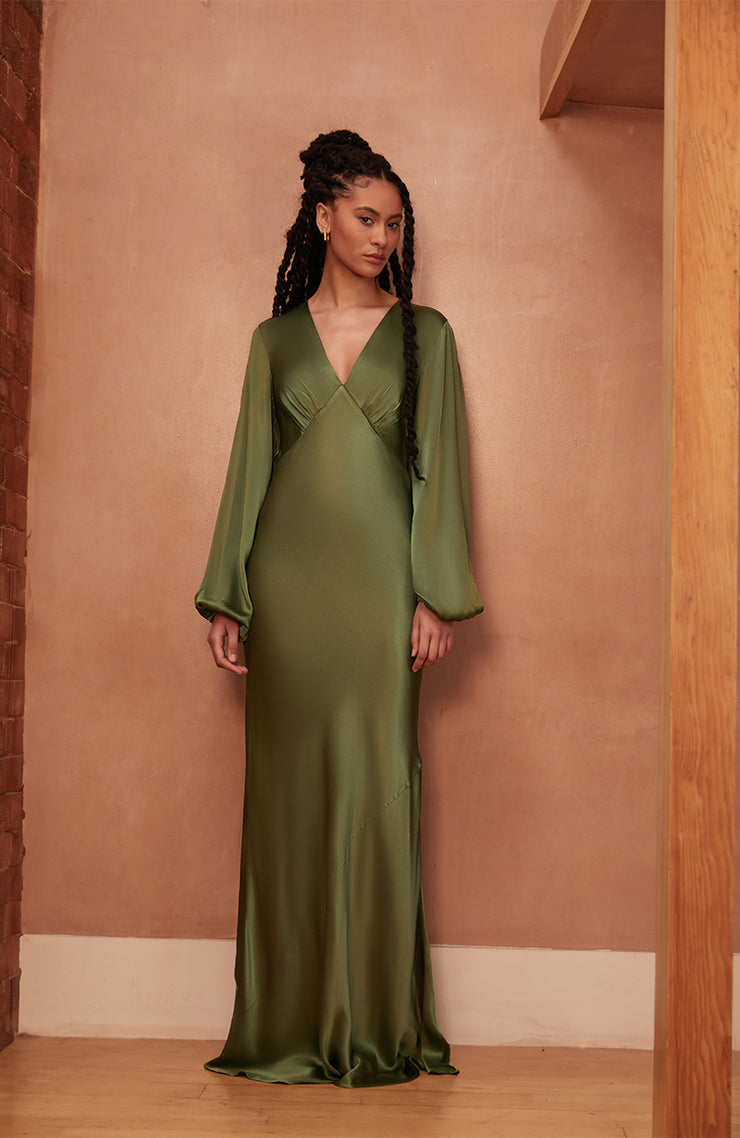 Woman wearing a Rewritten long green dress with long sleeves