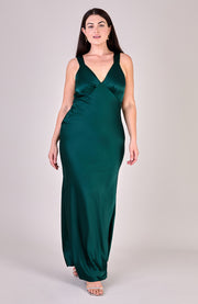 Woman wearing a green evening gown on a plain background