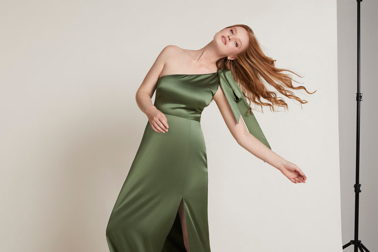 Olive green satin one shoulder dress with a split. Contemporary and modern bridesmaid dress