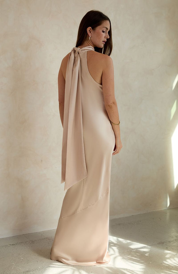 Champagne satin halterneck bridesmaids and black tie wedding guest occasion wear dress.